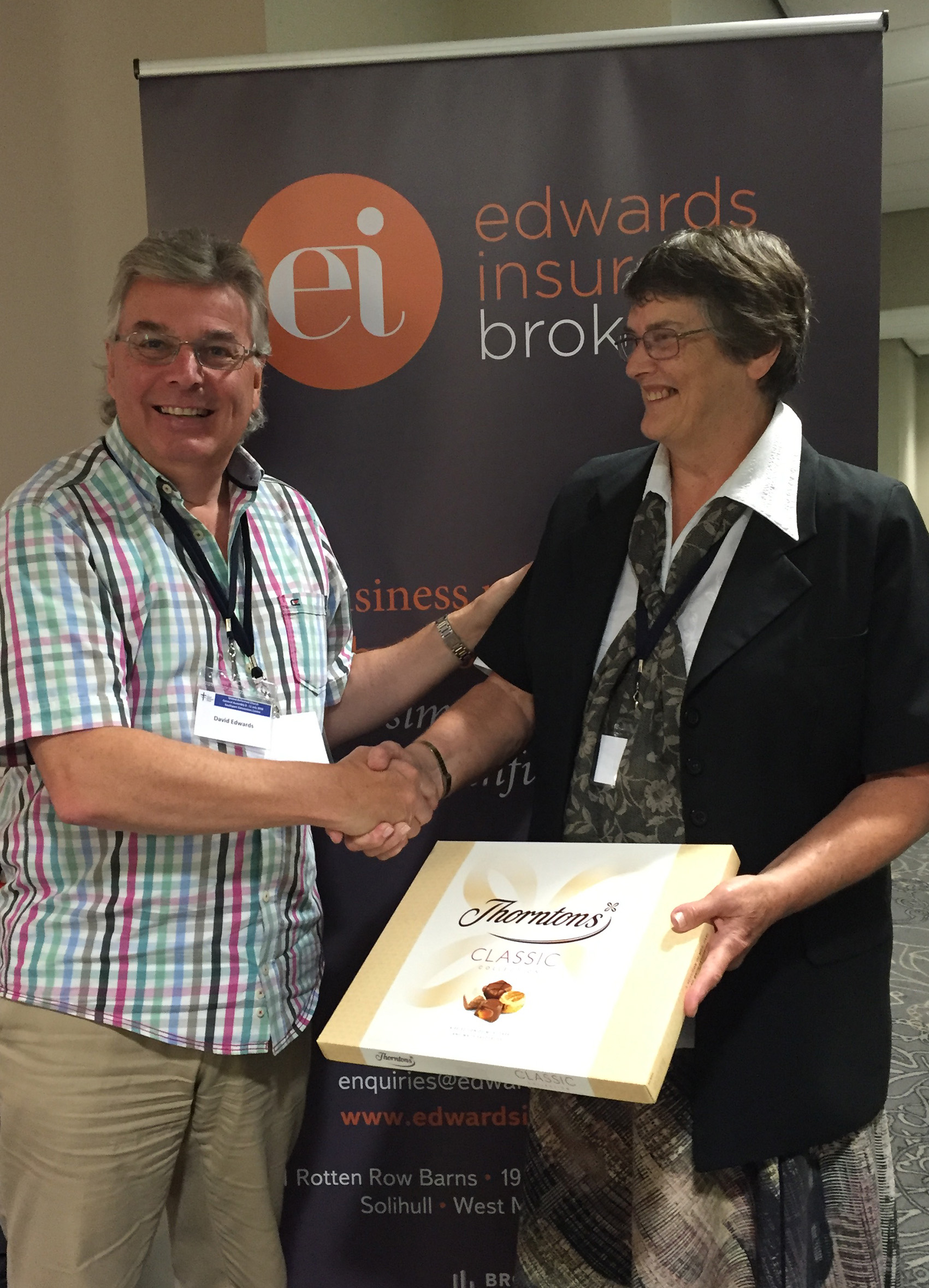 competition winner Rev. Ann Woodhurst receives chocolate prize at URC General Assembly